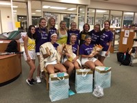 The seniors showing off the gift bags they received from the team on Senior Night.